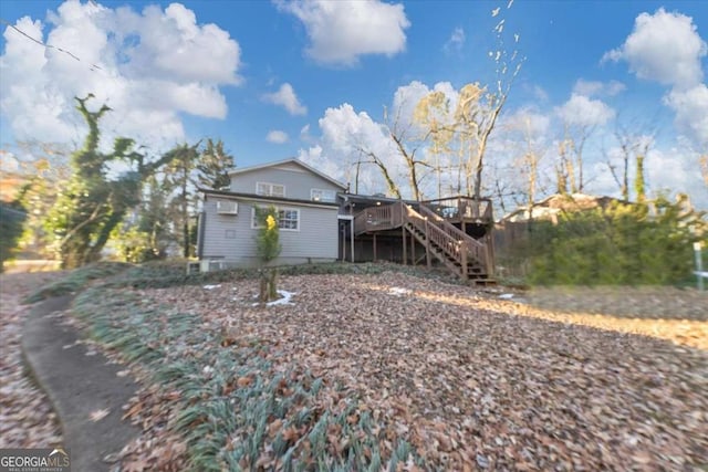 view of front of home with stairs and a wooden deck