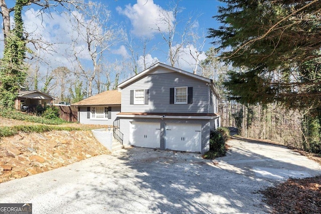 view of front of home featuring brick siding, driveway, and an attached garage