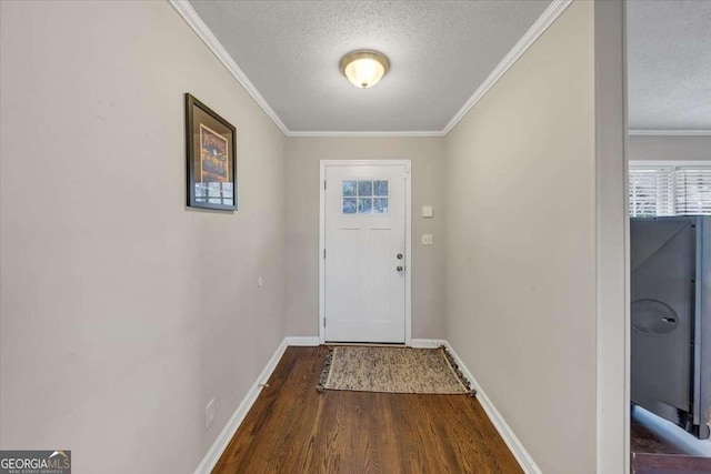 doorway with crown molding, a textured ceiling, baseboards, and wood finished floors