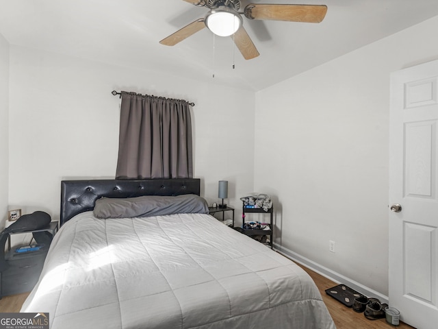 bedroom with hardwood / wood-style floors and ceiling fan