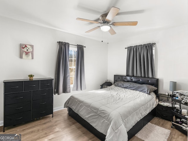 bedroom featuring hardwood / wood-style flooring and ceiling fan