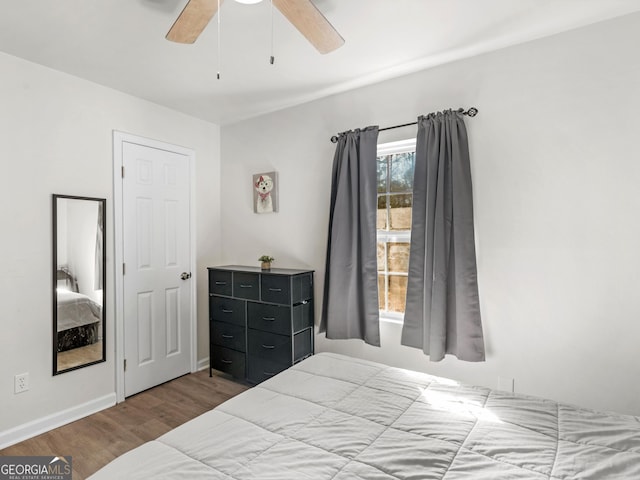 bedroom featuring wood-type flooring and ceiling fan