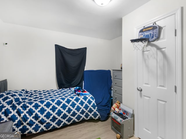 bedroom with hardwood / wood-style floors