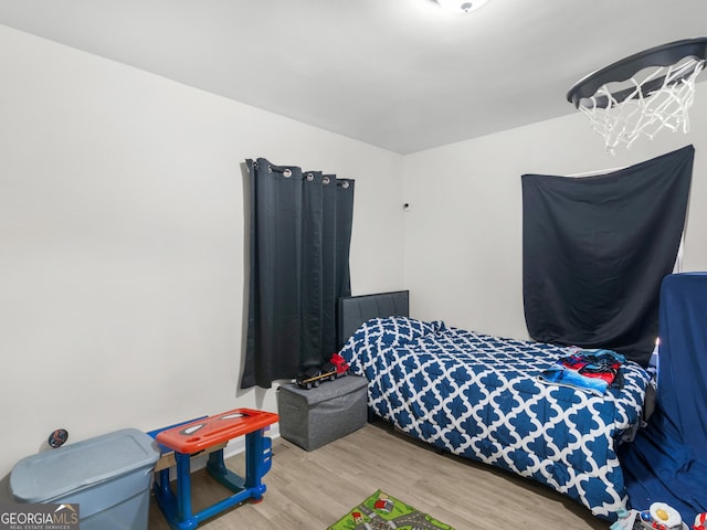 bedroom with hardwood / wood-style floors