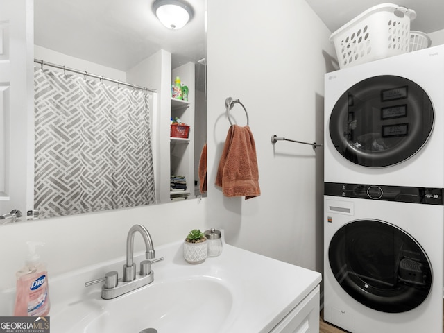 bathroom featuring vanity and stacked washer / drying machine