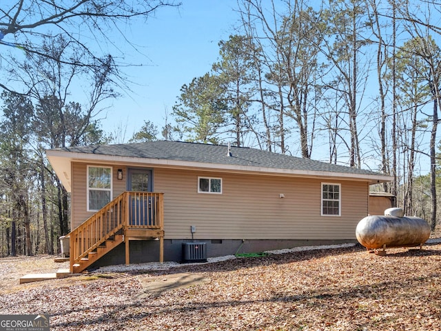 rear view of house with central AC