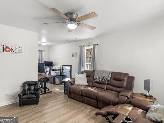 living room with ceiling fan and light hardwood / wood-style flooring