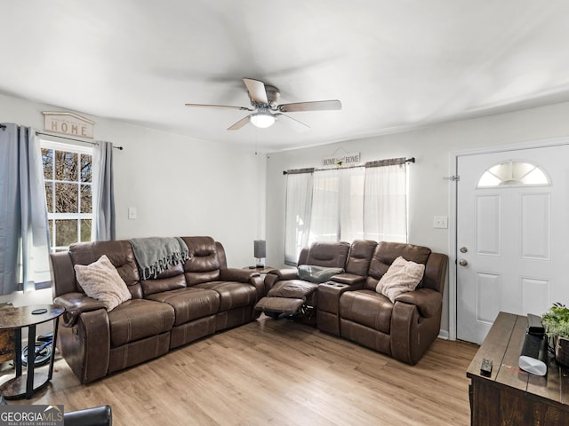 living room with light hardwood / wood-style floors and ceiling fan