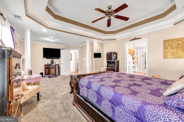 bedroom featuring a tray ceiling, decorative columns, visible vents, and carpet flooring