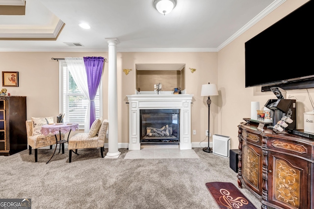 living area featuring visible vents, ornamental molding, a glass covered fireplace, carpet flooring, and ornate columns