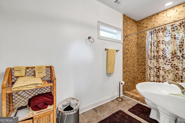 full bathroom with a sink, a stall shower, tile patterned flooring, and visible vents