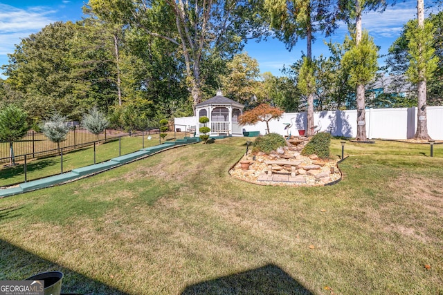 view of yard featuring fence and a gazebo