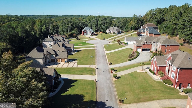 birds eye view of property featuring a residential view and a wooded view