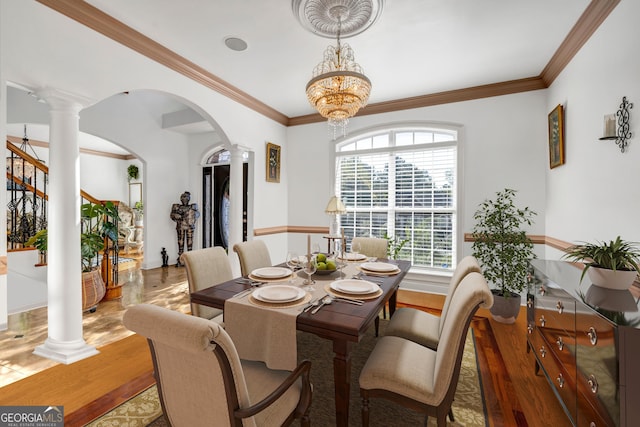 dining area with arched walkways, a notable chandelier, wood finished floors, ornamental molding, and decorative columns