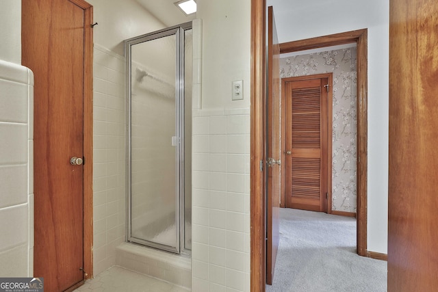 bathroom featuring a shower with shower door