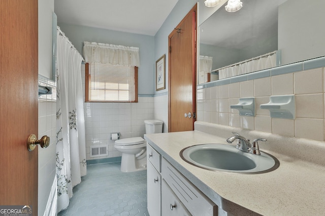 bathroom featuring tile walls, tile patterned floors, vanity, and toilet