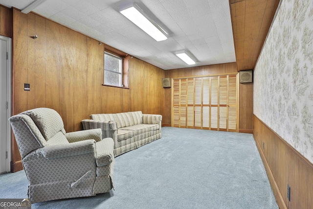 living room featuring light carpet and wooden walls