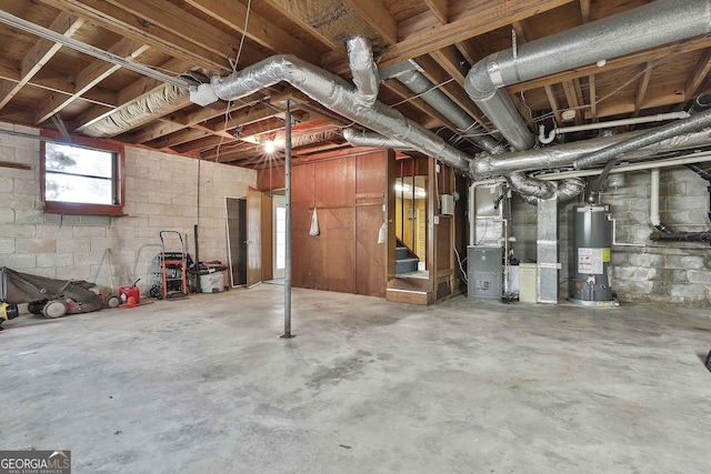 basement featuring heating unit and water heater