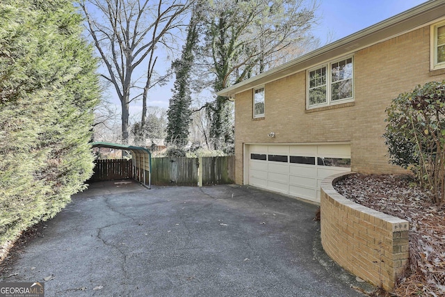 view of side of property featuring a carport and a garage