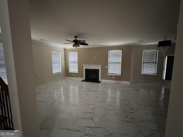 unfurnished living room featuring ceiling fan and ornamental molding