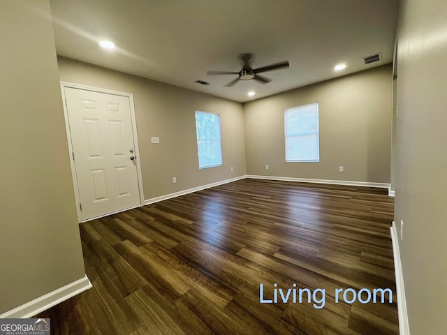 unfurnished room featuring ceiling fan and dark hardwood / wood-style flooring