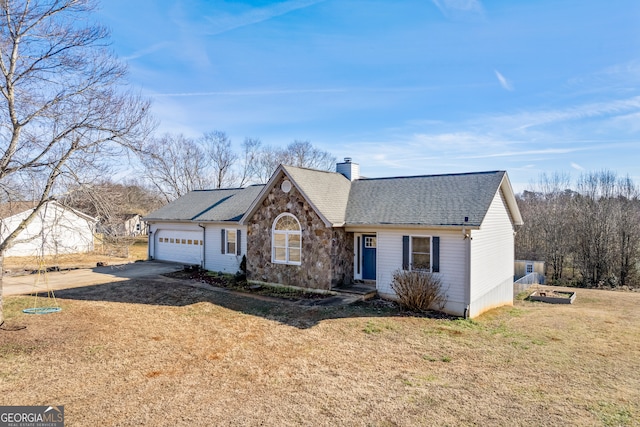 view of front of house featuring a garage and a front lawn