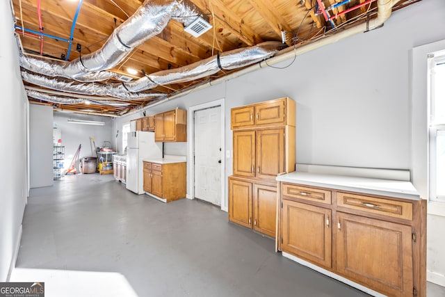 basement featuring white fridge