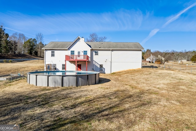 rear view of property with a yard