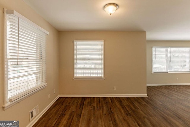 spare room featuring dark wood-type flooring