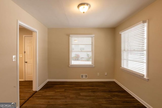 empty room featuring dark hardwood / wood-style flooring