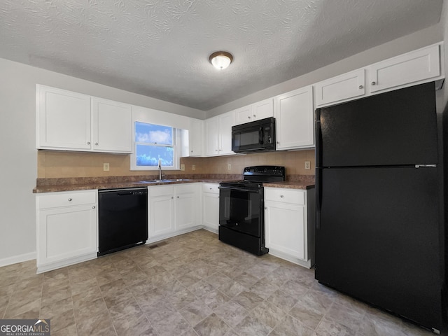 kitchen with a textured ceiling, sink, white cabinets, and black appliances