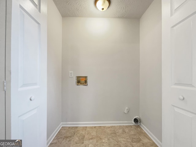 laundry area with hookup for a washing machine and a textured ceiling