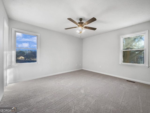 empty room featuring ceiling fan and carpet flooring