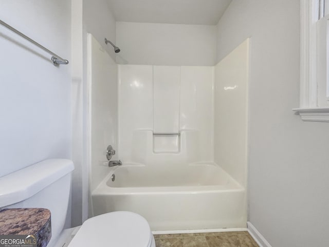 bathroom featuring toilet and shower / bath combination