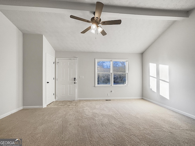 unfurnished living room featuring ceiling fan, light colored carpet, a textured ceiling, and lofted ceiling with beams