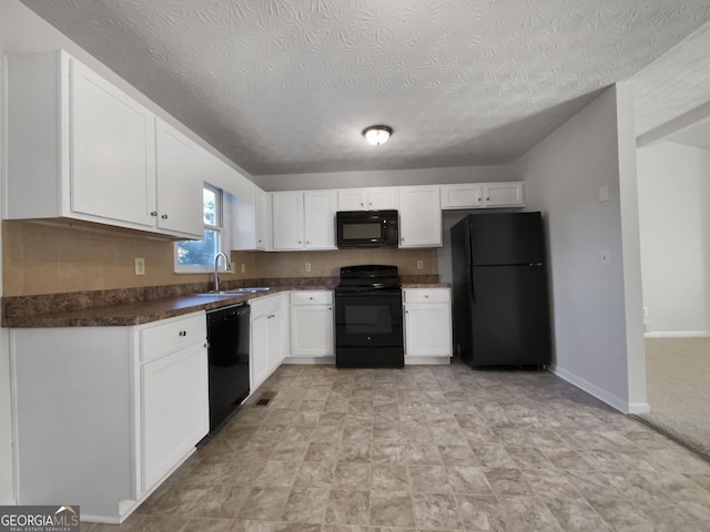 kitchen with black appliances, white cabinets, sink, and a textured ceiling