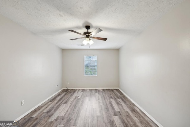 unfurnished room with a textured ceiling, ceiling fan, and hardwood / wood-style flooring