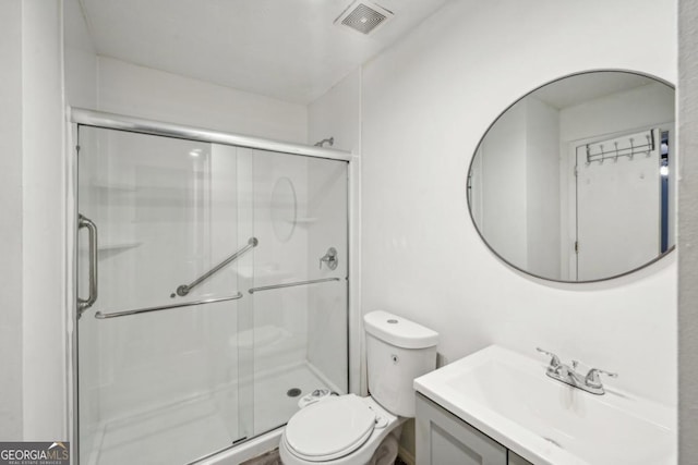 bathroom featuring toilet, walk in shower, and vanity