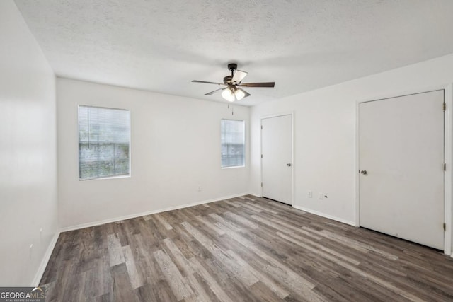 spare room featuring ceiling fan, a textured ceiling, and hardwood / wood-style flooring