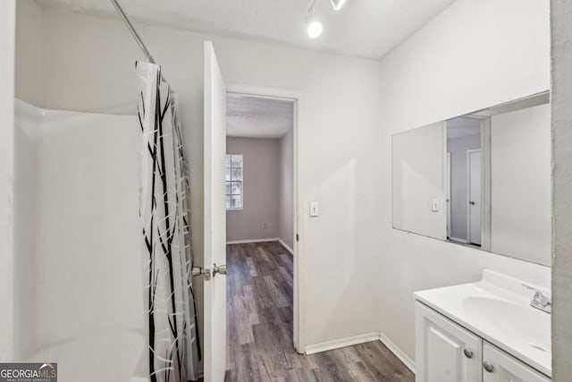 bathroom with hardwood / wood-style flooring and vanity