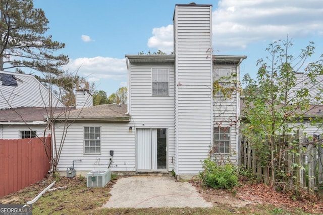 rear view of property with a patio area and central air condition unit