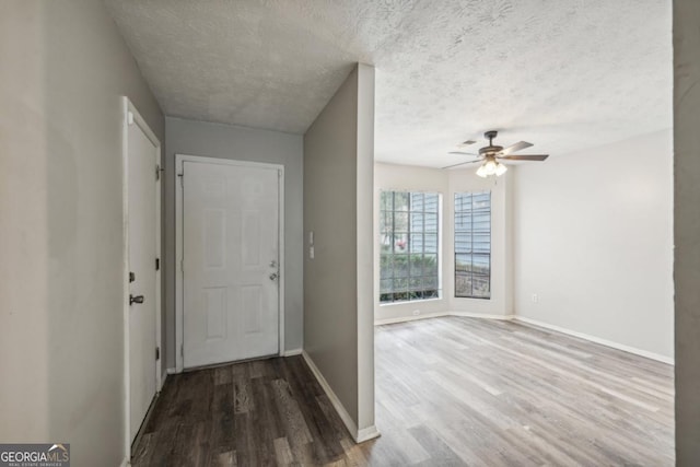 foyer featuring ceiling fan, hardwood / wood-style floors, and a textured ceiling