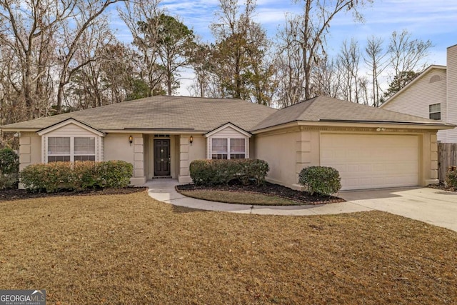 single story home with a garage and a front lawn