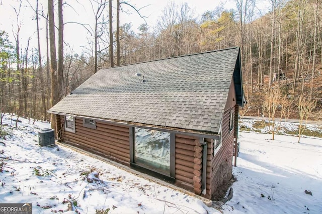 view of snowy exterior with central air condition unit