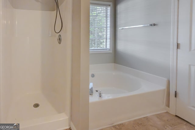 bathroom featuring independent shower and bath