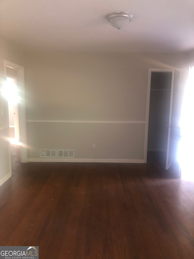 unfurnished room featuring dark hardwood / wood-style floors