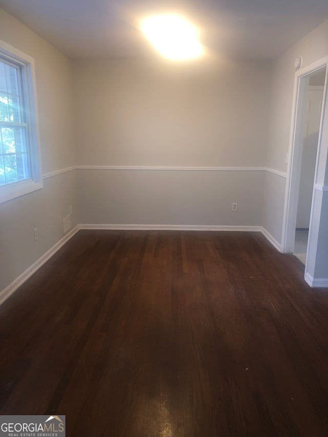 unfurnished room with dark hardwood / wood-style floors