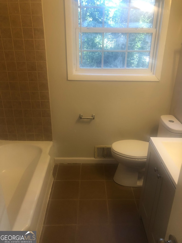 bathroom with tile patterned floors, vanity, and toilet