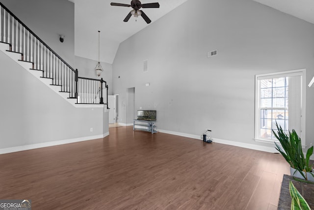 unfurnished living room featuring ceiling fan, dark hardwood / wood-style flooring, and high vaulted ceiling