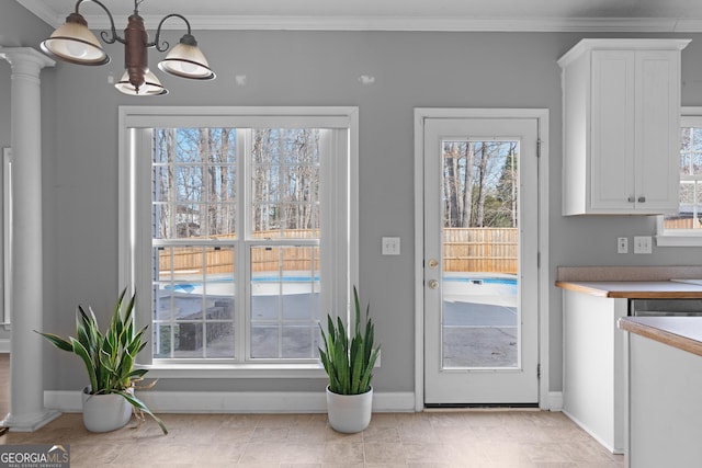 doorway with a notable chandelier and crown molding